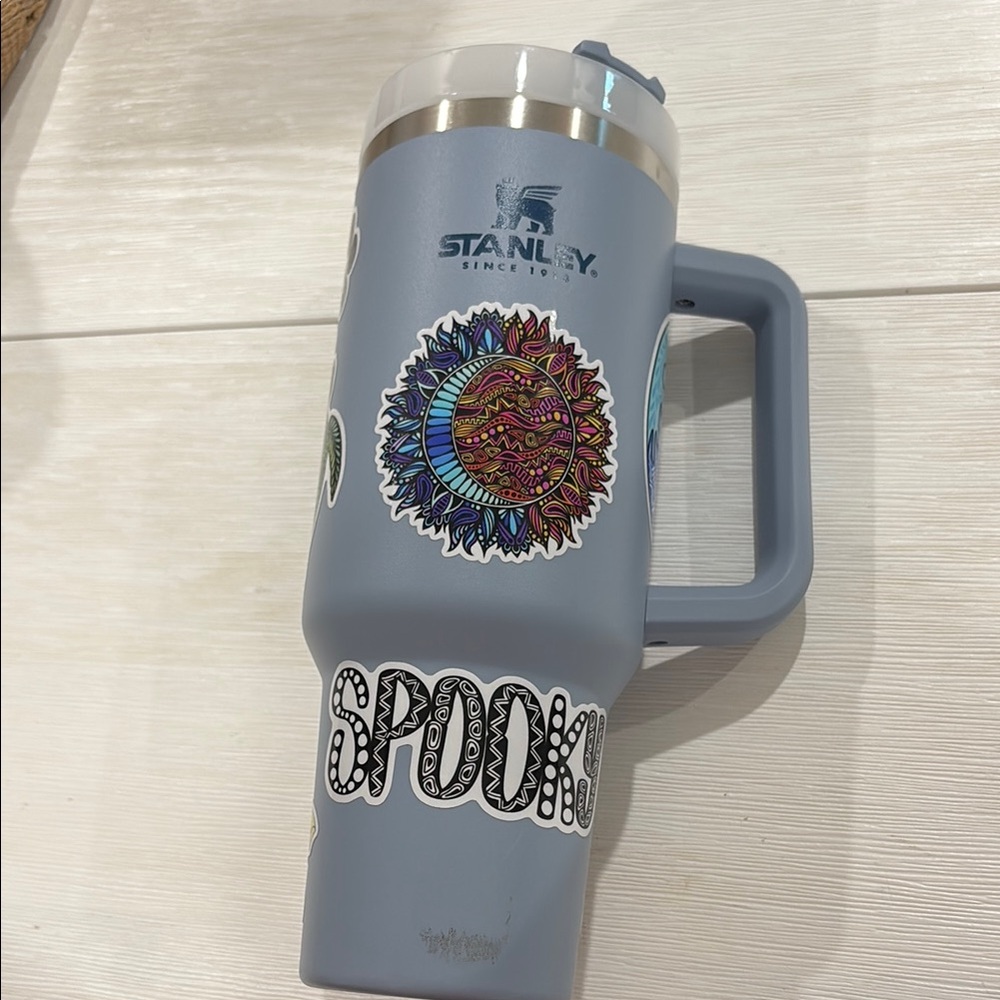 Stanley Blue Travel Mug with Vibrant Stickers